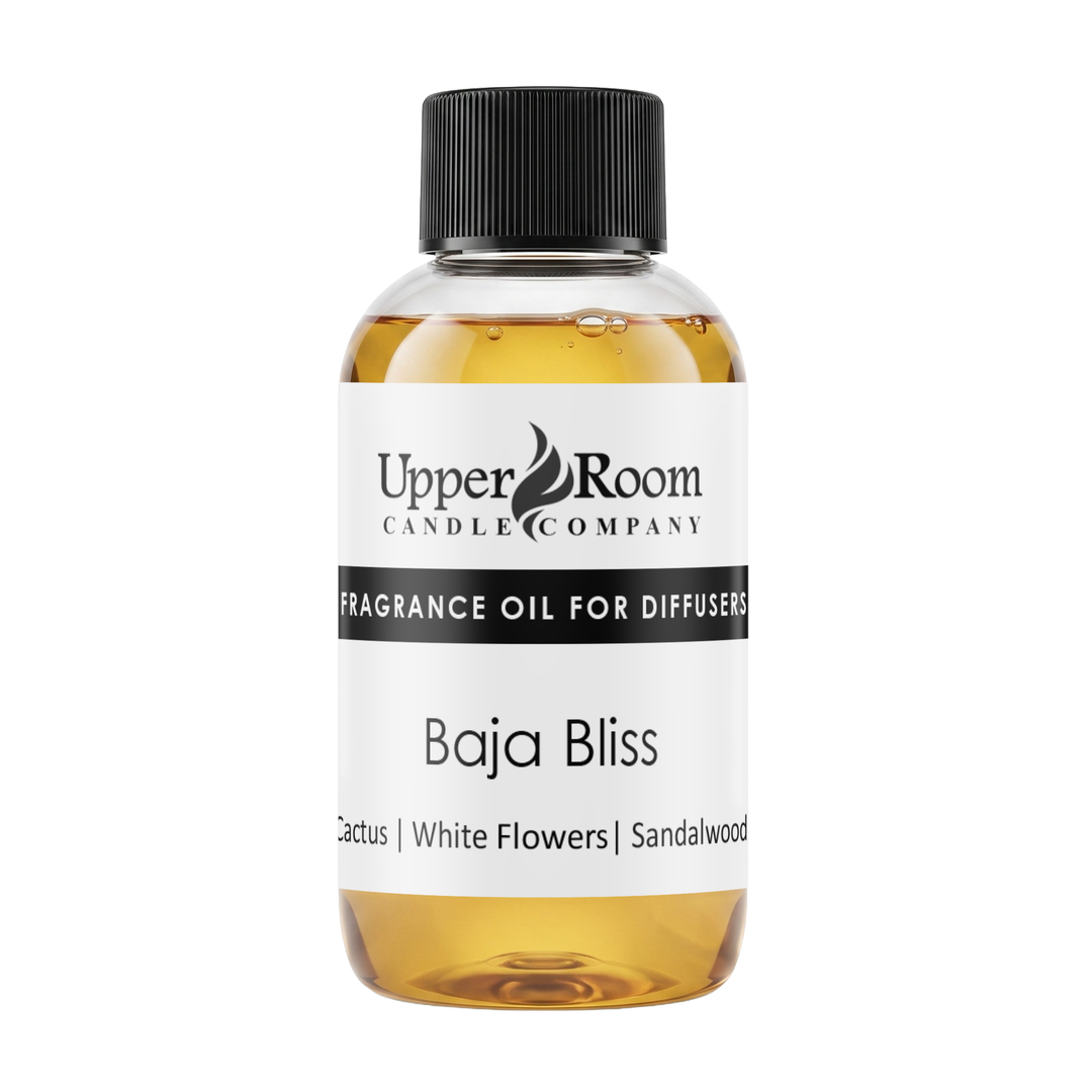 A bottle of Upper Room Candle Company Baja Bliss fragrance oil for diffusers, featuring amber-colored liquid, a white label with black text, and a black ribbed cap, set against a plain white background.