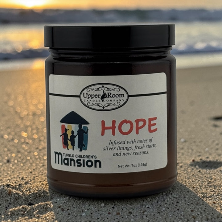 Hope Candle single wick amber jar upper room candle company on a beach
