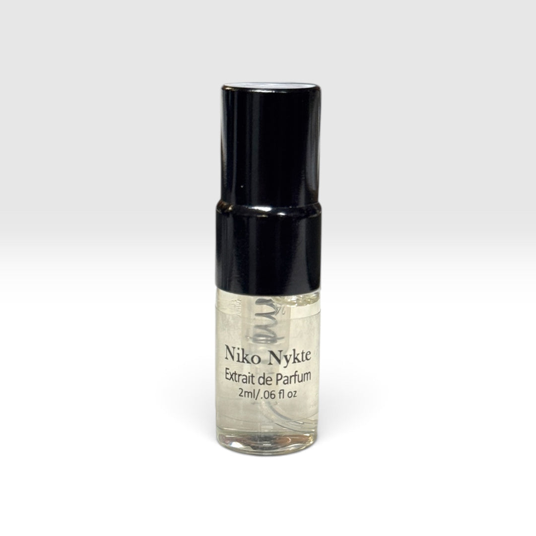 Niko Nykte extrait de parfum 2ml by Upper Room Fragrances in a square blue glass bottle with black cap, featuring a fresh masculine scent of mint, green apple, Italian lemon, cedarwood, vetiver and oakmoss.