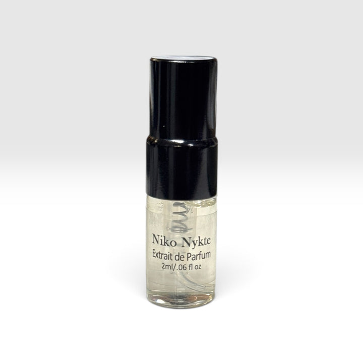 Niko Nykte extrait de parfum 2ml by Upper Room Fragrances in a square blue glass bottle with black cap, featuring a fresh masculine scent of mint, green apple, Italian lemon, cedarwood, vetiver and oakmoss.