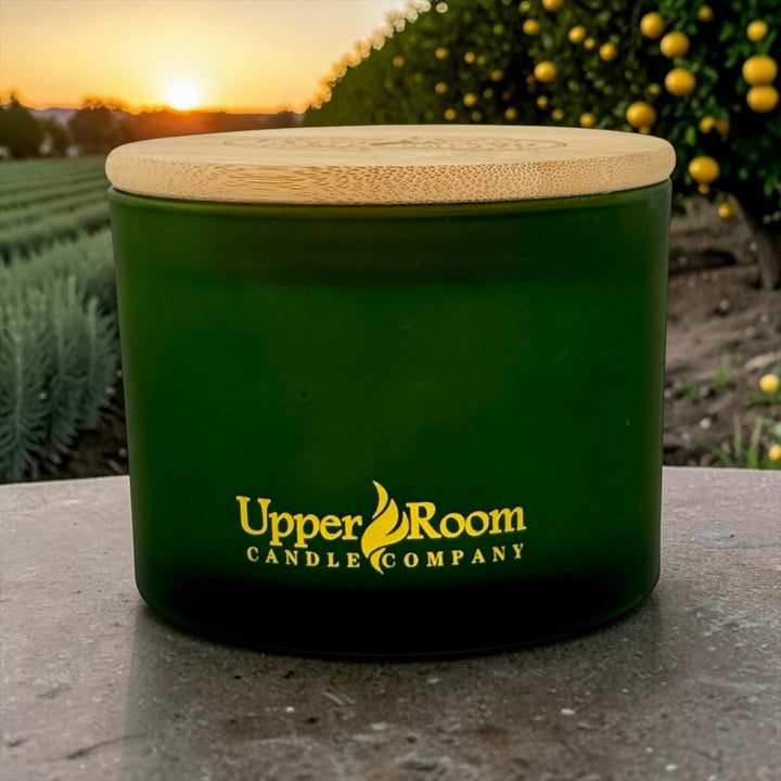 Rosemary Citrus hand-poured soy wax blend candle by Upper Room Candle Company in an amber jar with black lid, featuring rosemary, eucalyptus, lemon, lime, sage and cedar for a fresh herbal citrus scent.