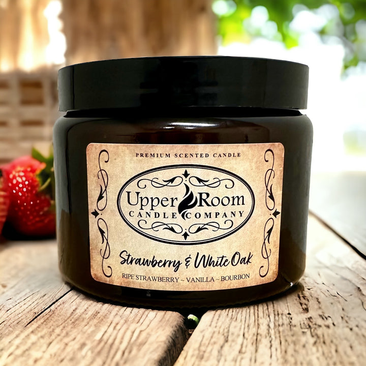 Strawberry and white oak candle in a double wick amber jar from upper room candle company