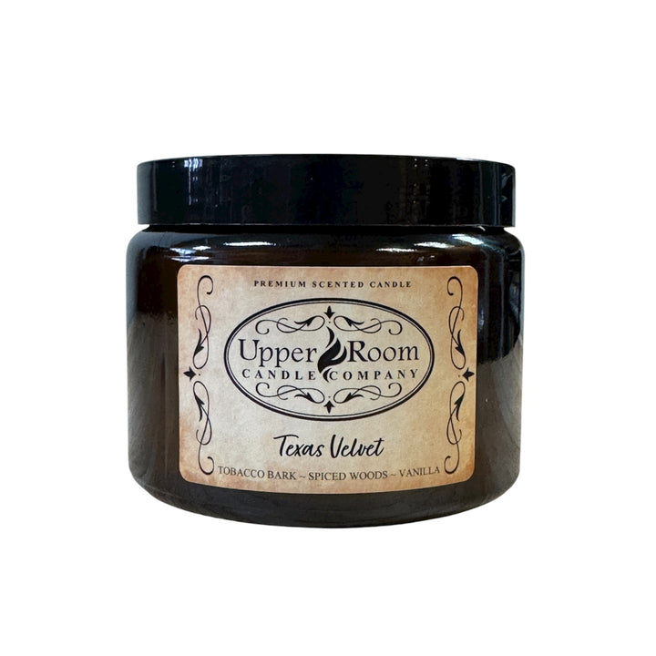 Texas Velvet Candle in a double wick amber jar from upper room candle company, white background