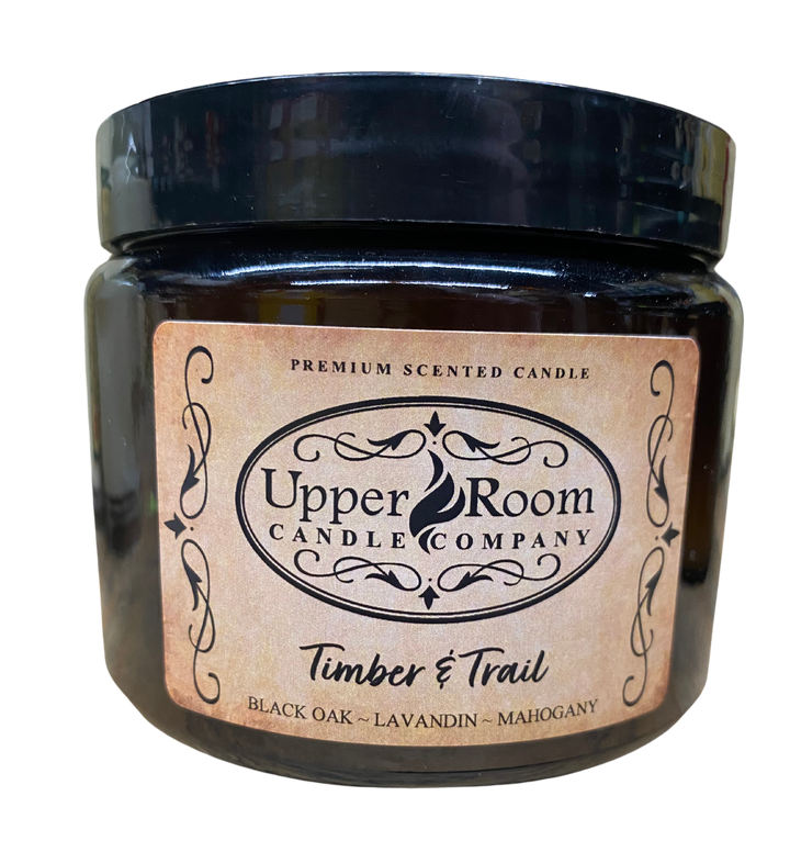 Timber & Trail candle in a double wick amber jar from upper room candle company