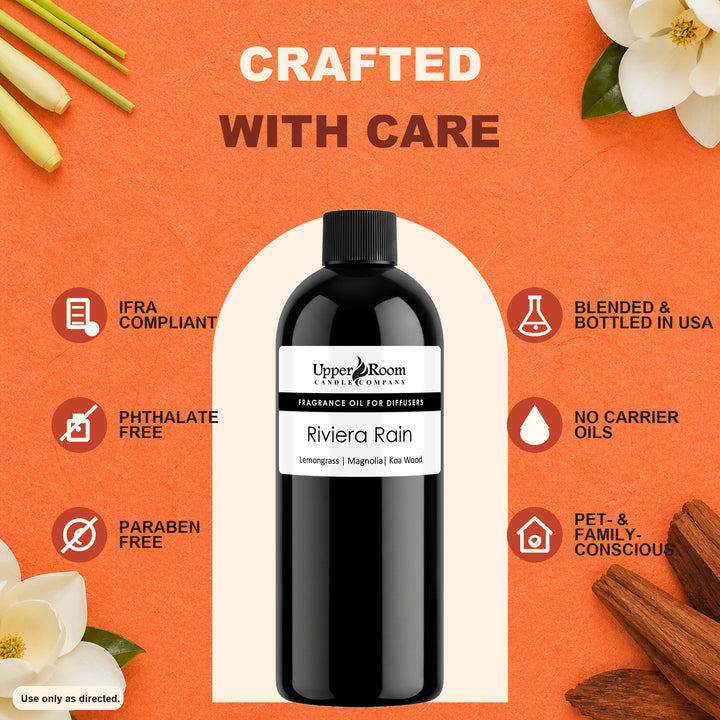 A bottle of Upper Room Apothecary 'Riviera Rain' fragrance oil for diffusers, presented on a textured orange background with decorative natural elements like cinnamon sticks, a white flower, and green stems. The image features marketing text overlays highlighting product features like 'IFRA COMPLIANT', 'PHTHALATE FREE', and 'BLENDED & BOTTLED IN USA'.